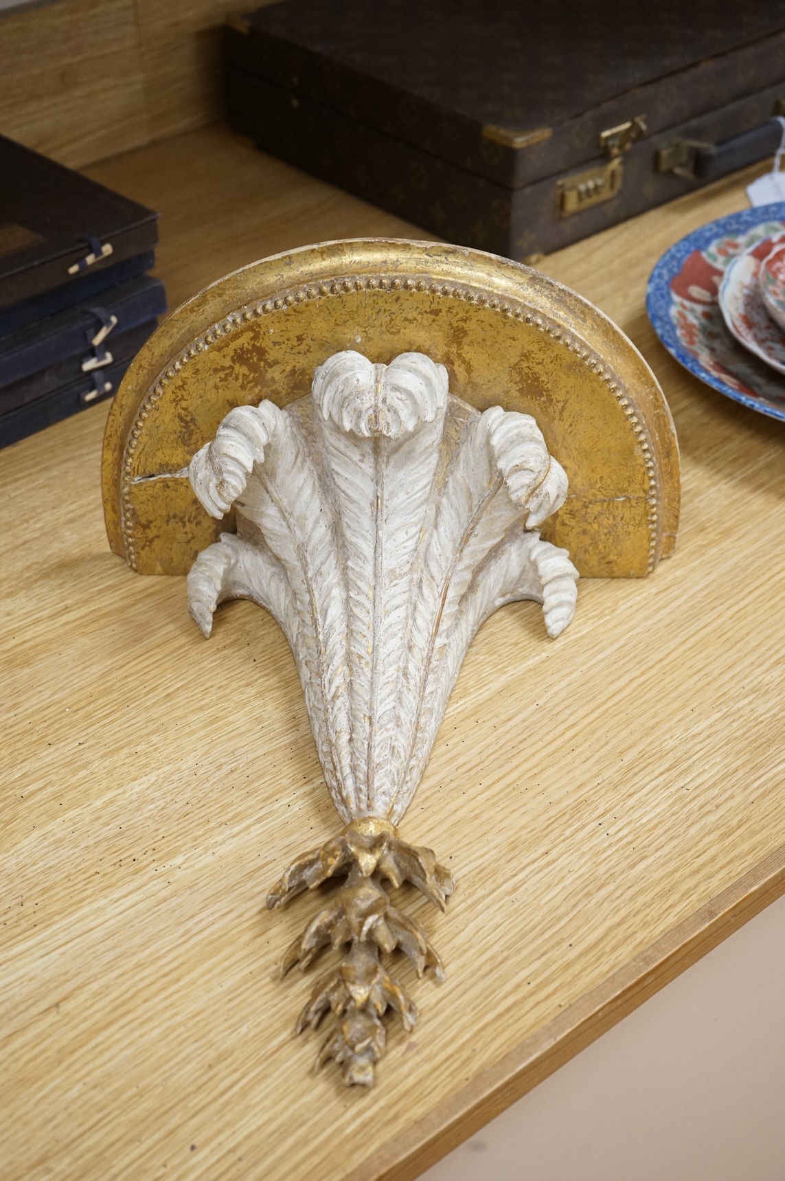 A George III cream painted and giltwood wall bracket, 35cm